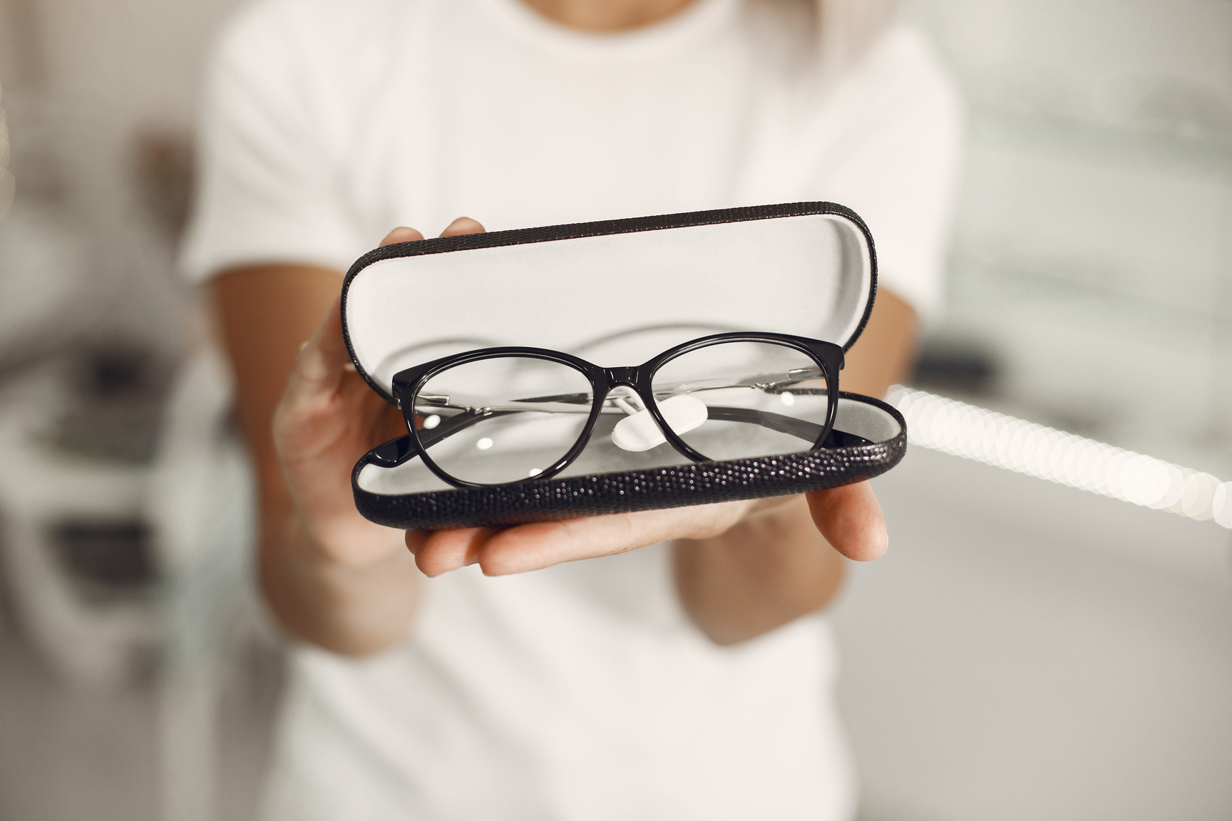 Woman Holding Case with Glasses at Optics Store